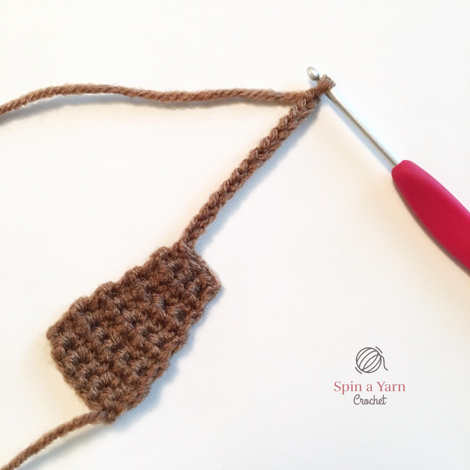 Crochet brown rounded ears and little resting paws