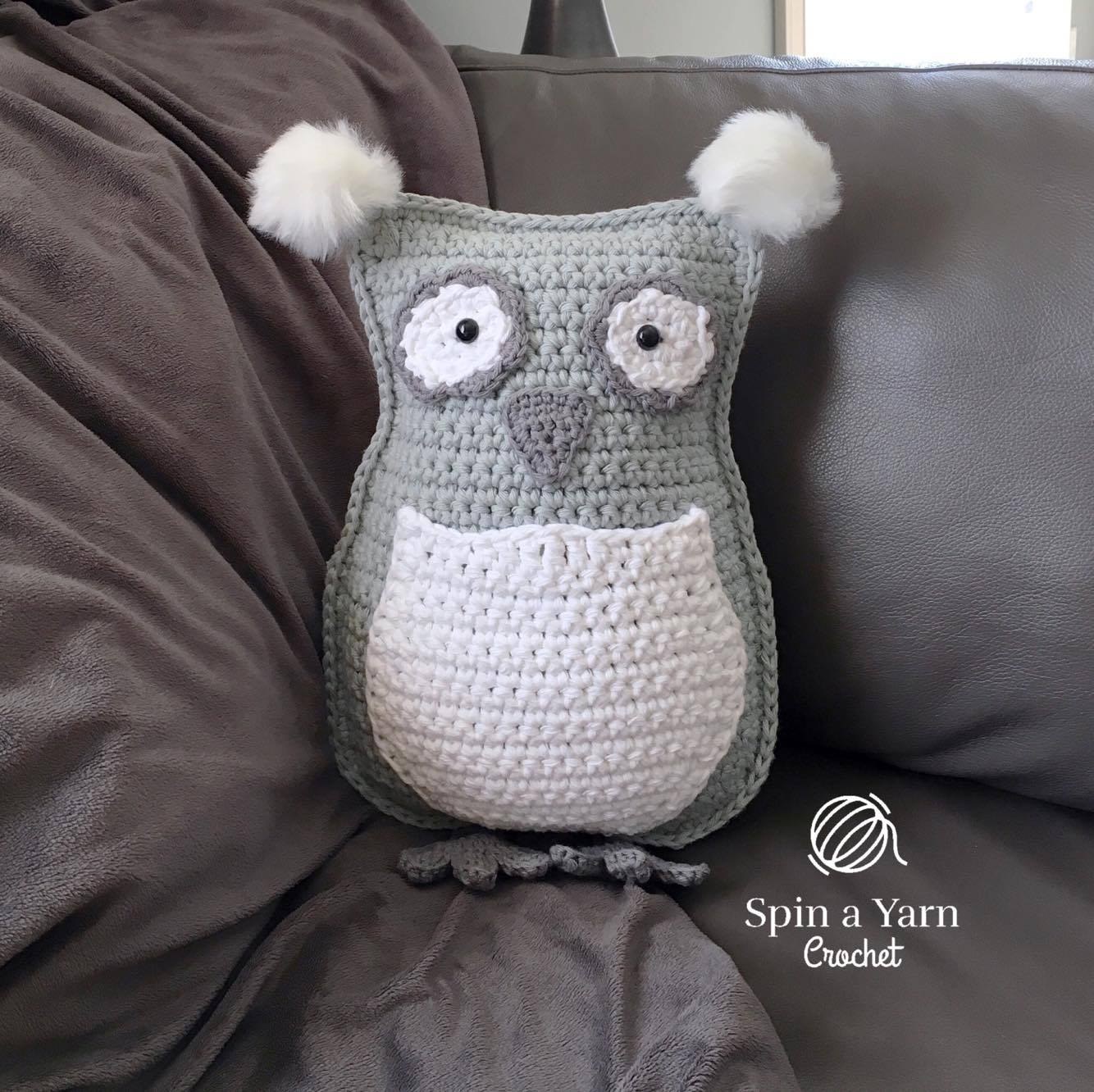 Single crocheting pillow edges together and adding fluffy ear pompoms