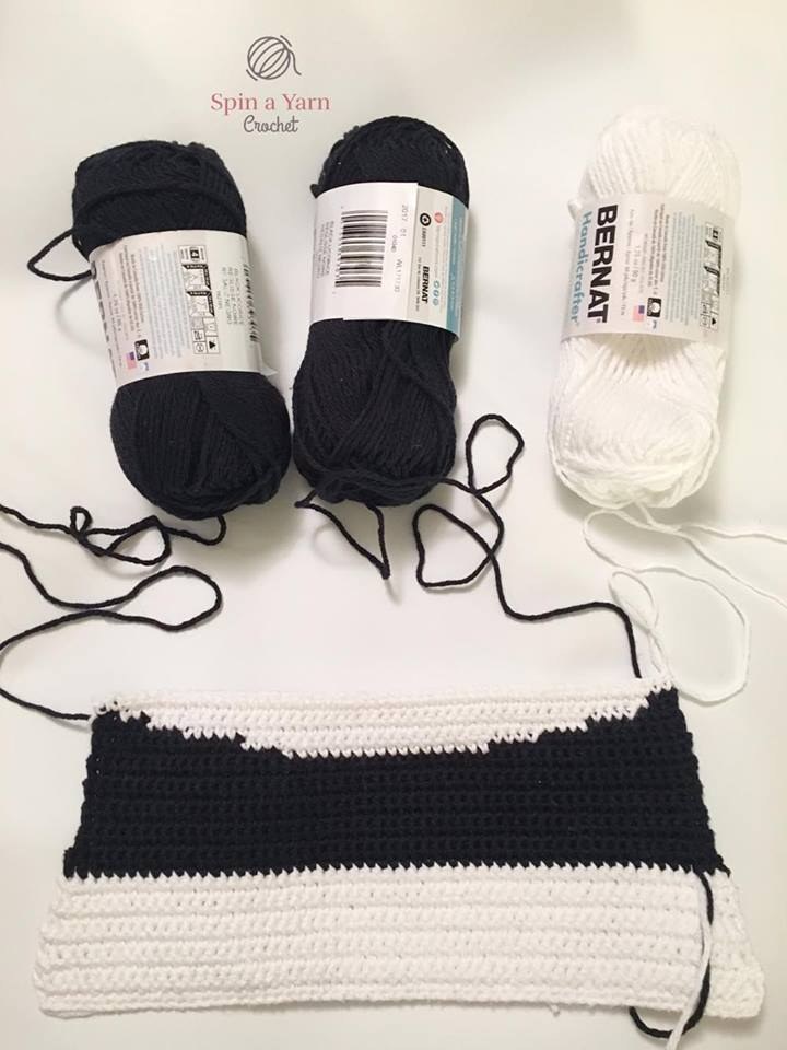 Crochet black rounded ears, arms, and stubby legs for panda