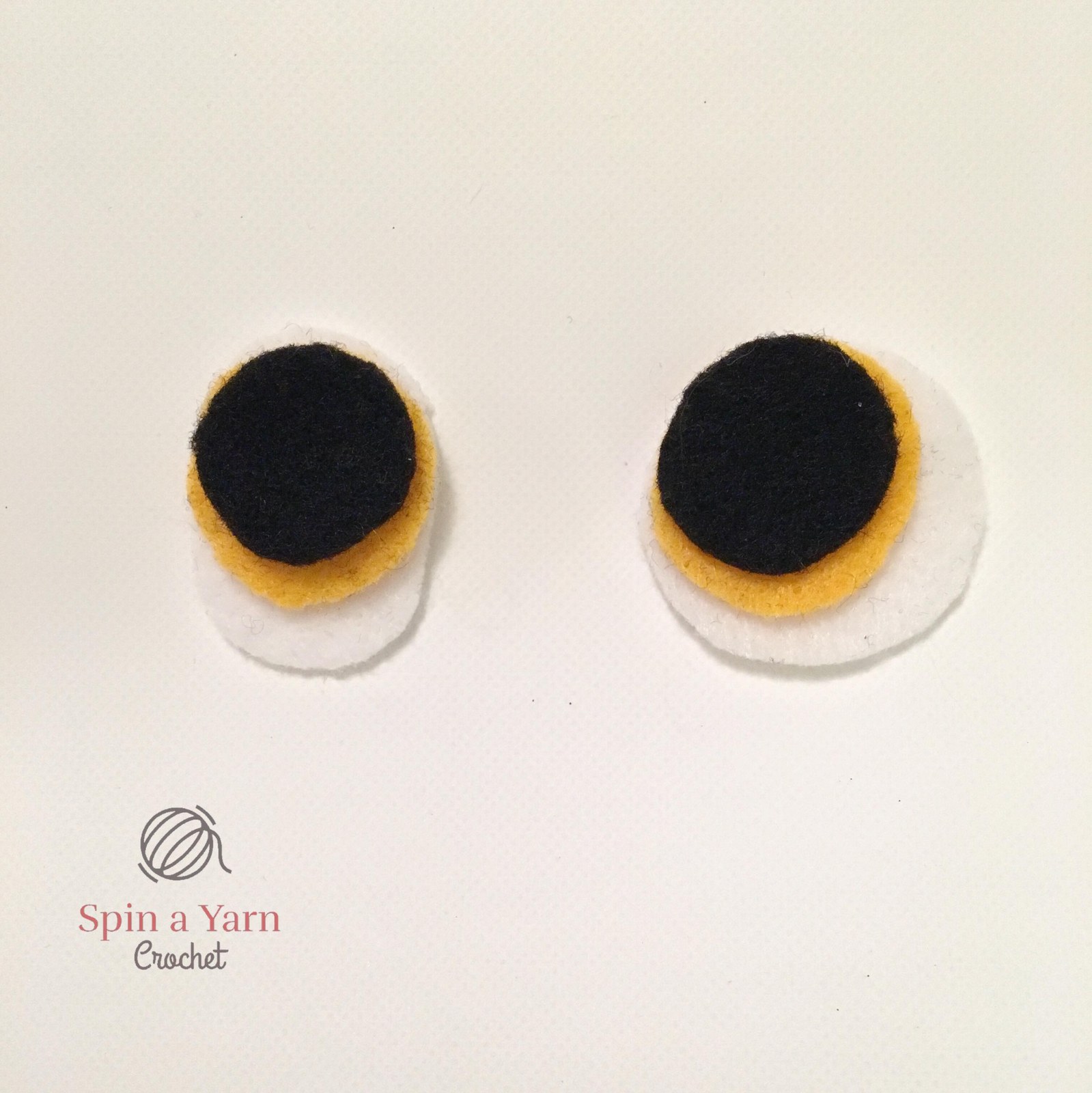 Crochet black tapered wings and bright orange webbed feet