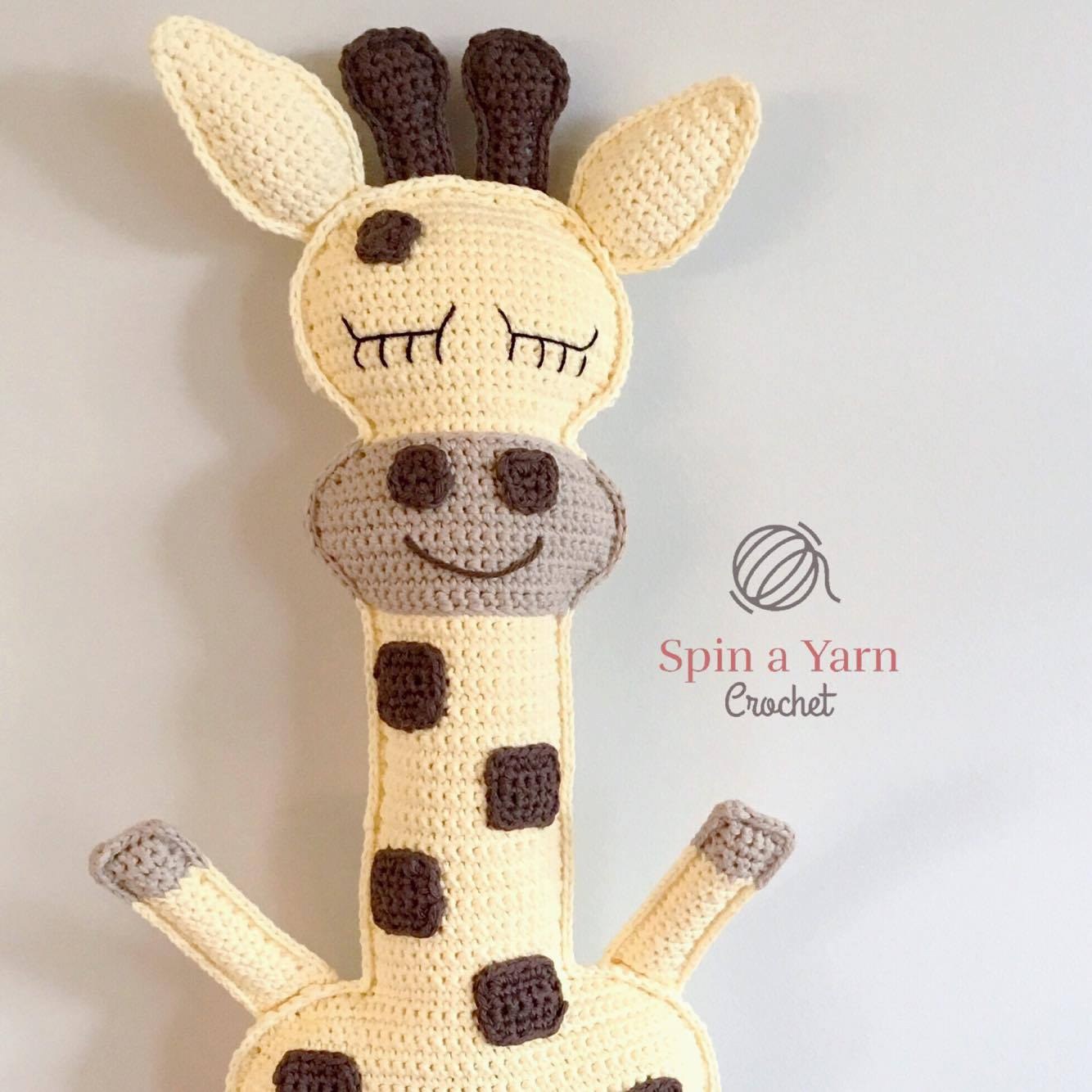 Cream oval muzzle, brown spots, and safety eyes pinned on giraffe