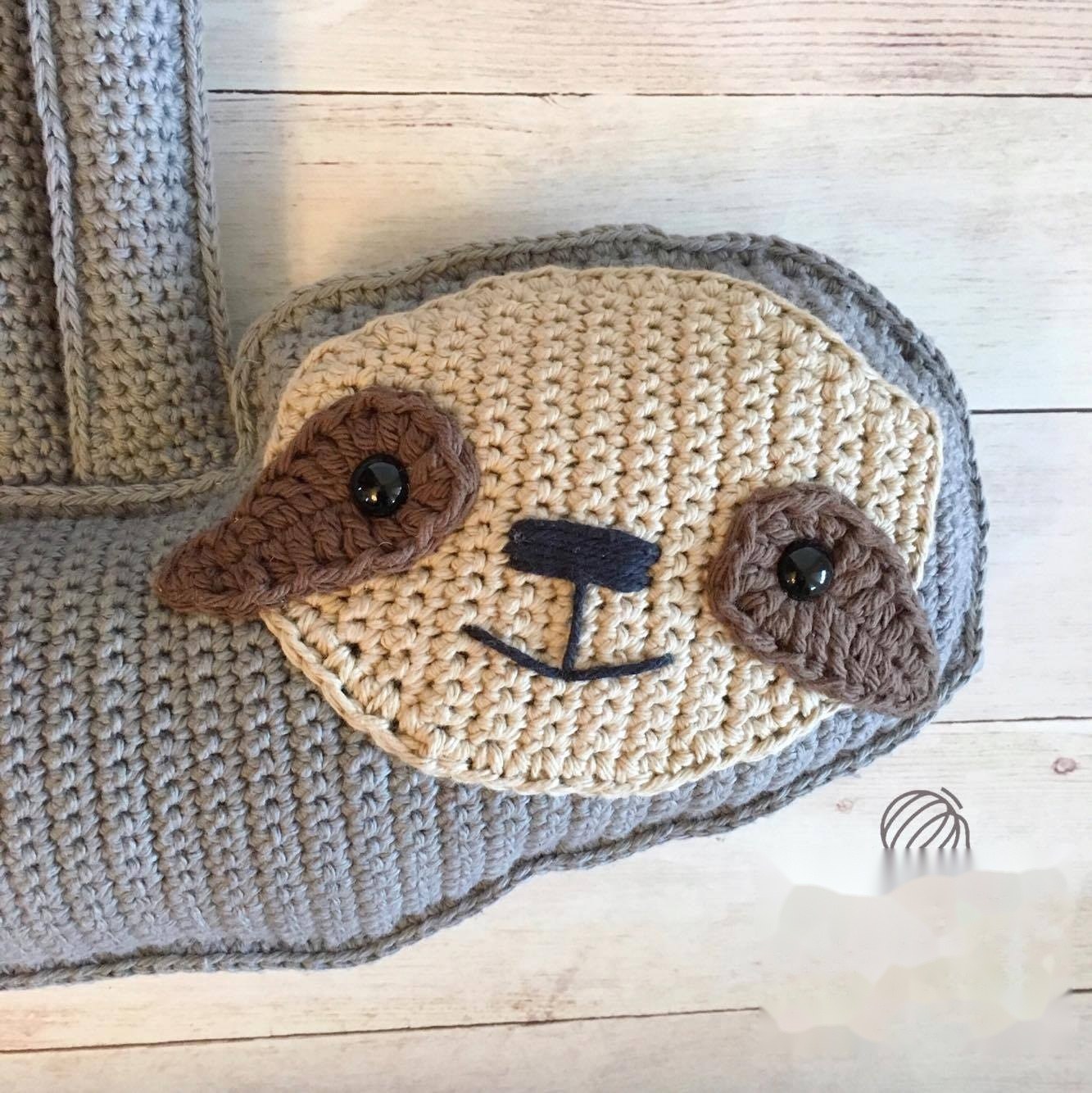 Whipstitching sloth face mask onto front tan body panel