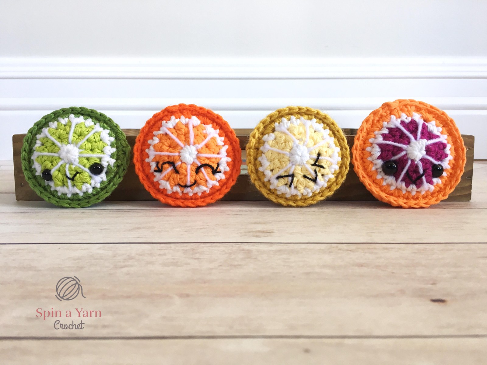 Four citrus fruit slices in a row
