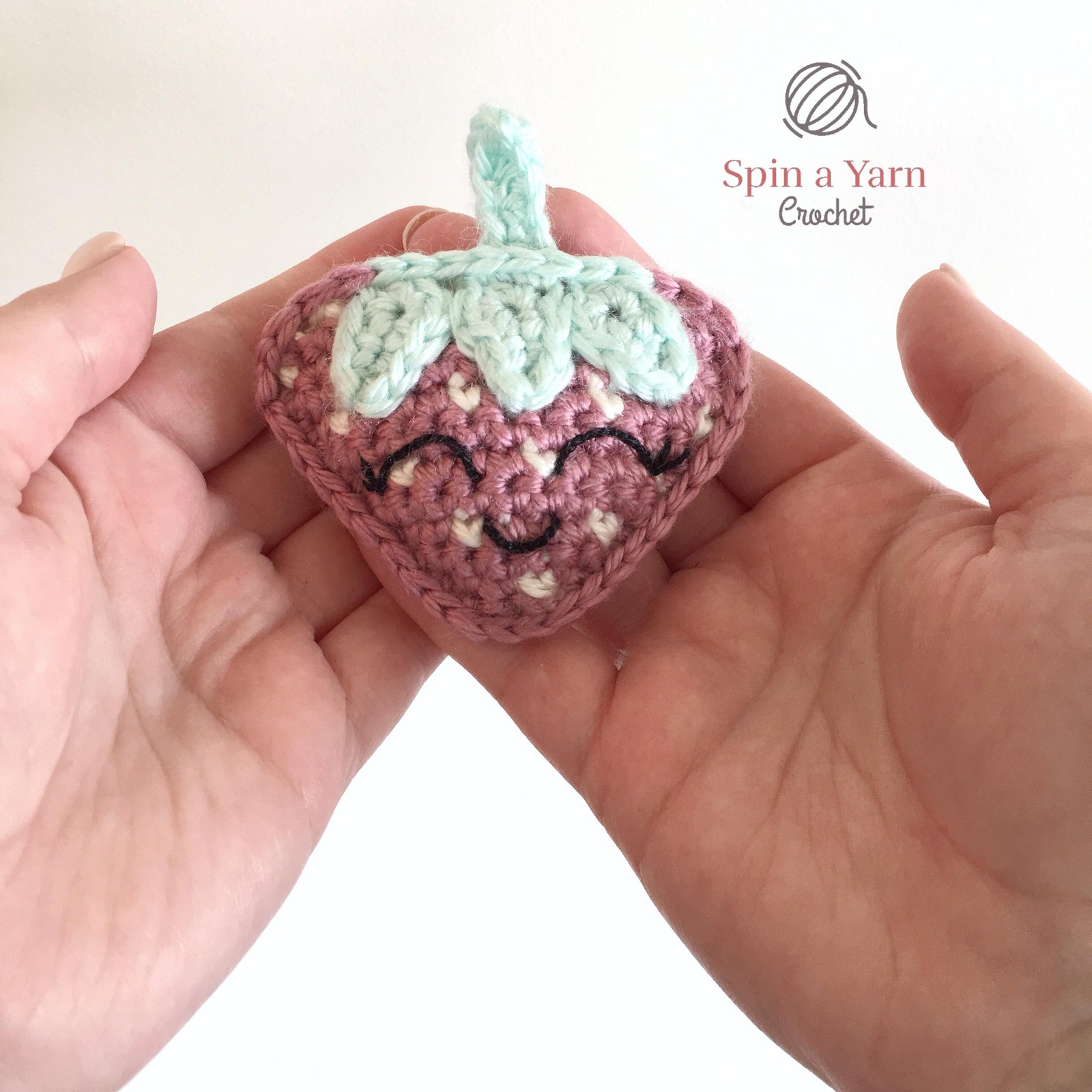 Crochet strawberry in hands