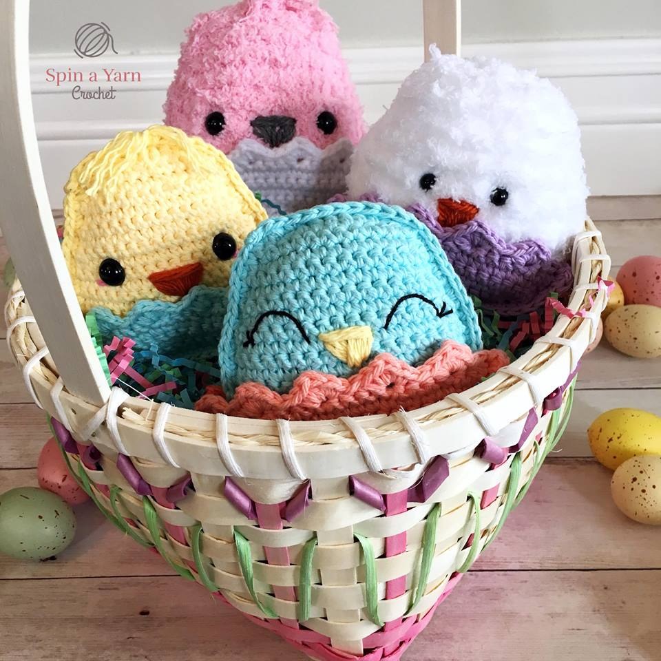 Four chubby crochet chicks in a basket