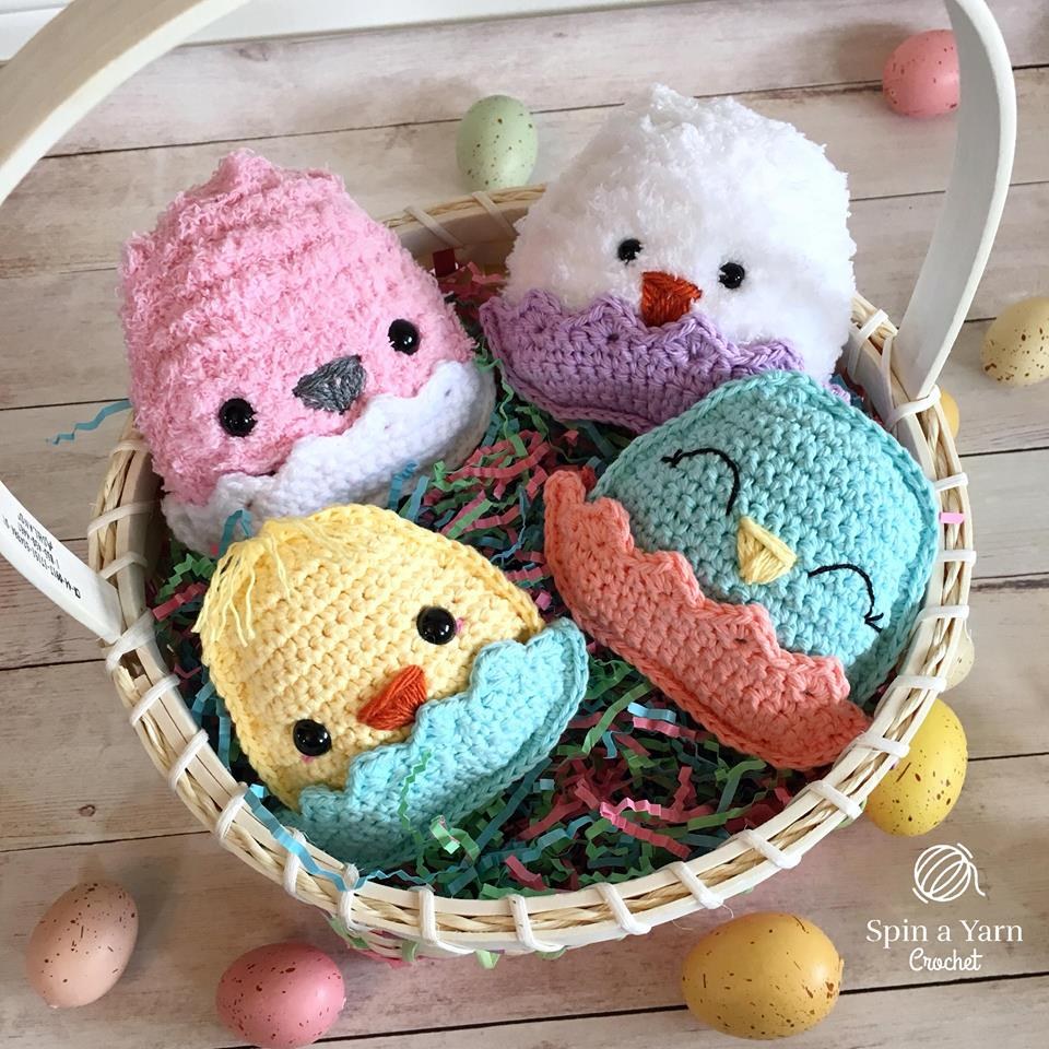 Four chubby crochet chicks in a basket