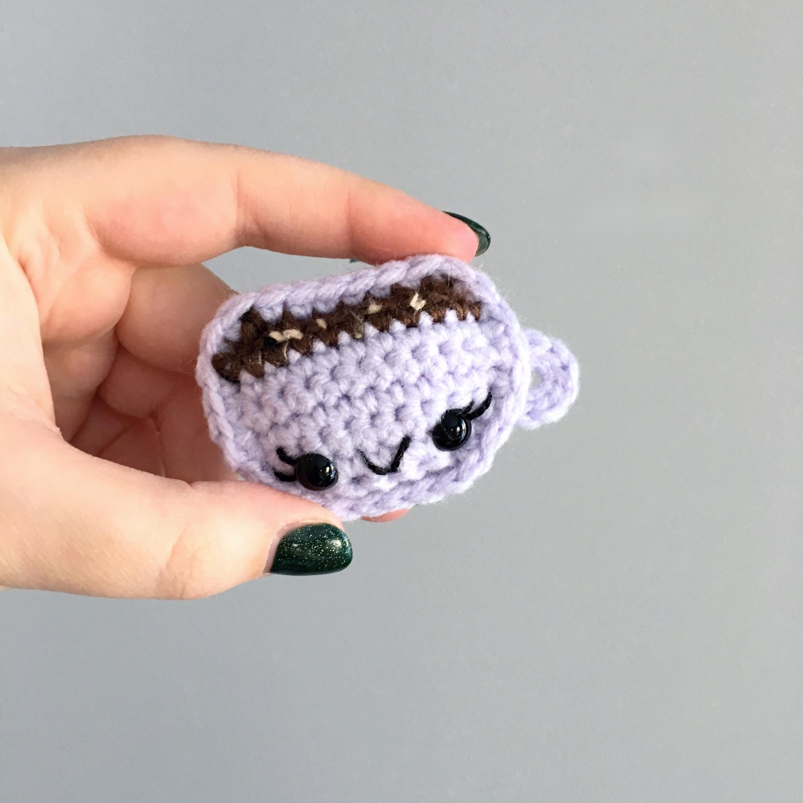 Hand holding purple mug