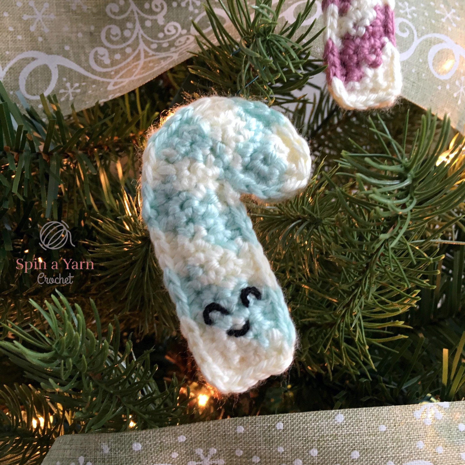 Mint and white candy cane ornament on tree