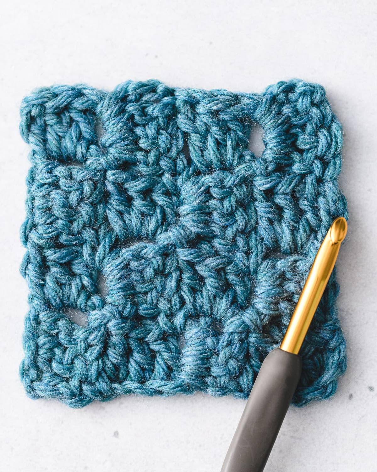 Diagonal corner-to-corner crochet square sample with distinct geometric tiles