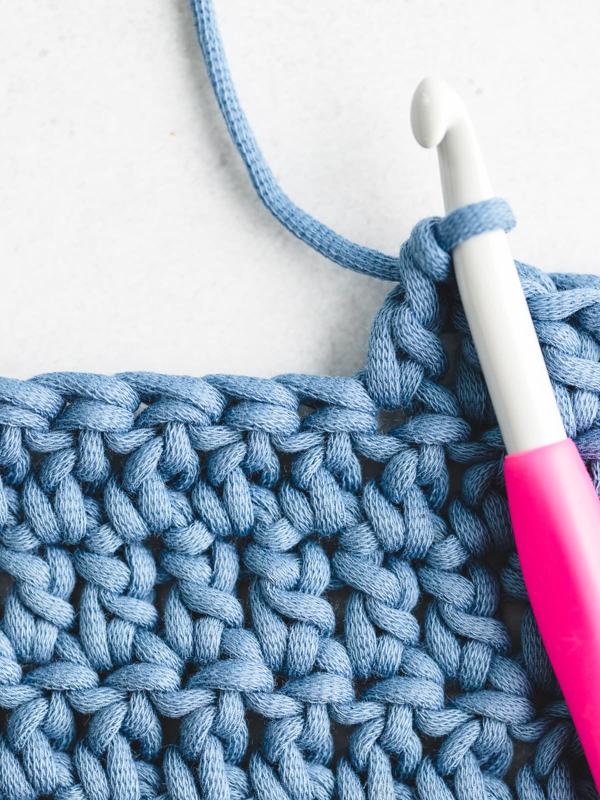 Double crochet fabric swatch demonstrating tall airy stitches with smooth edges