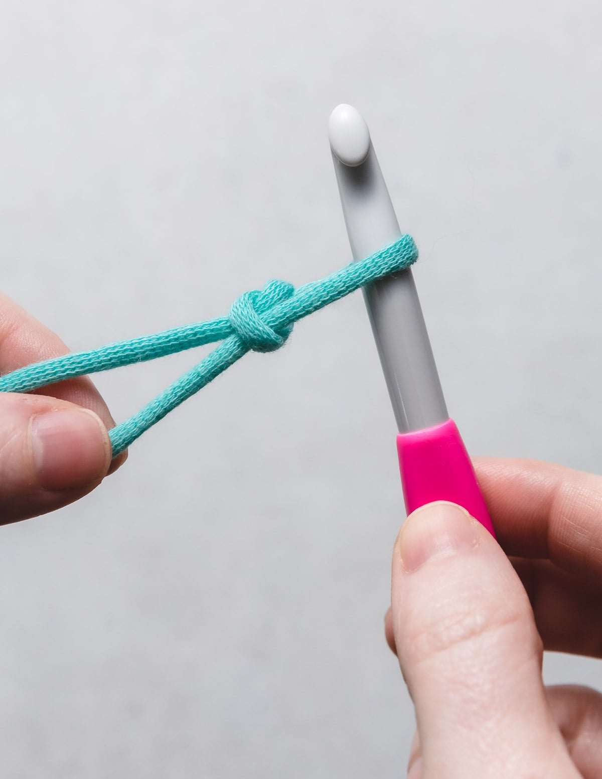 Yarn forming an adjustable pretzel slip knot cleanly on aluminum crochet hook