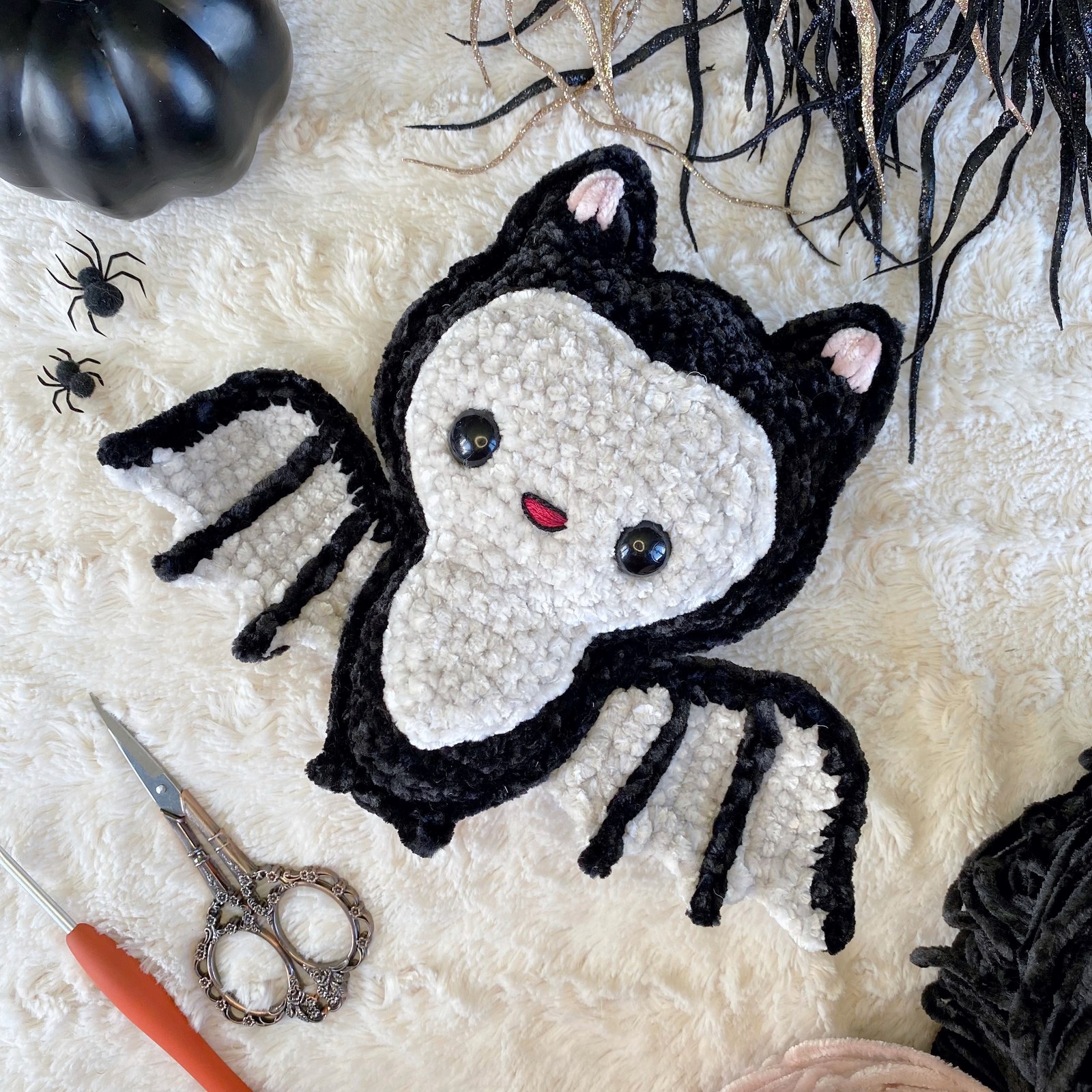 Finished ragdoll bat amigurumi in black velvet yarn with outstretched wings