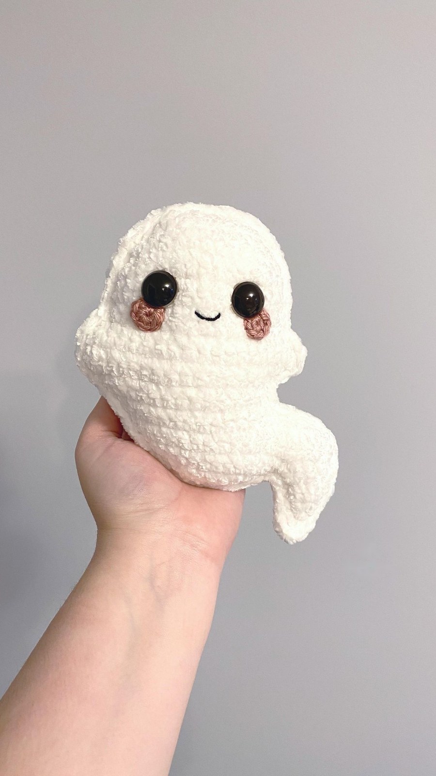 Finished ragdoll ghost amigurumi with blushing cheeks and wavy tail