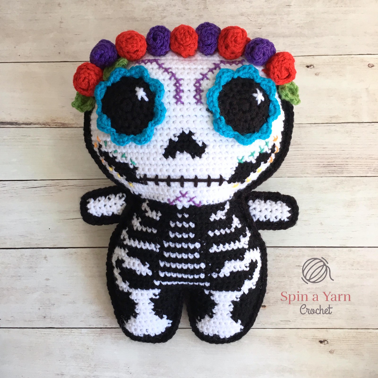 Finished crochet sugar skull with floral marigold crown and ornate eyes