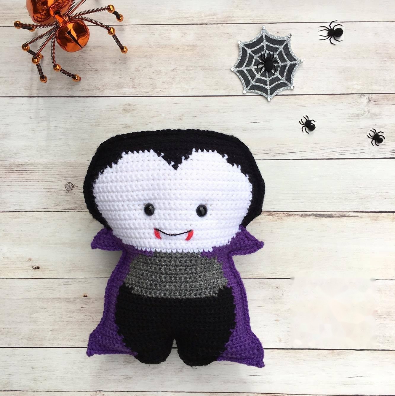 Finished crochet vampire Dracula with high-collared cape and fangs